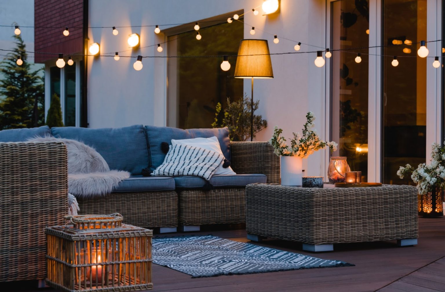 A close up on an outdoor ambient light hanging over a patio