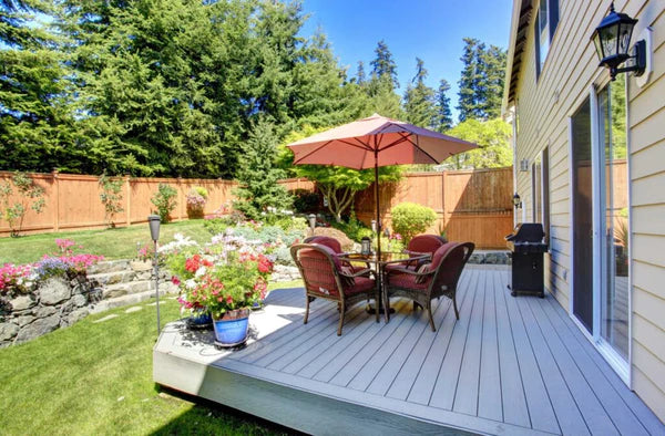A small deck with patio furniture arranged in a way that doesn't overcrowd the area
