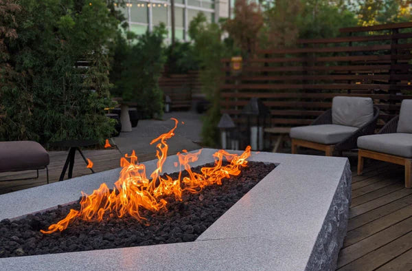A fire table surrounded by patio furniture to add warmth to the space