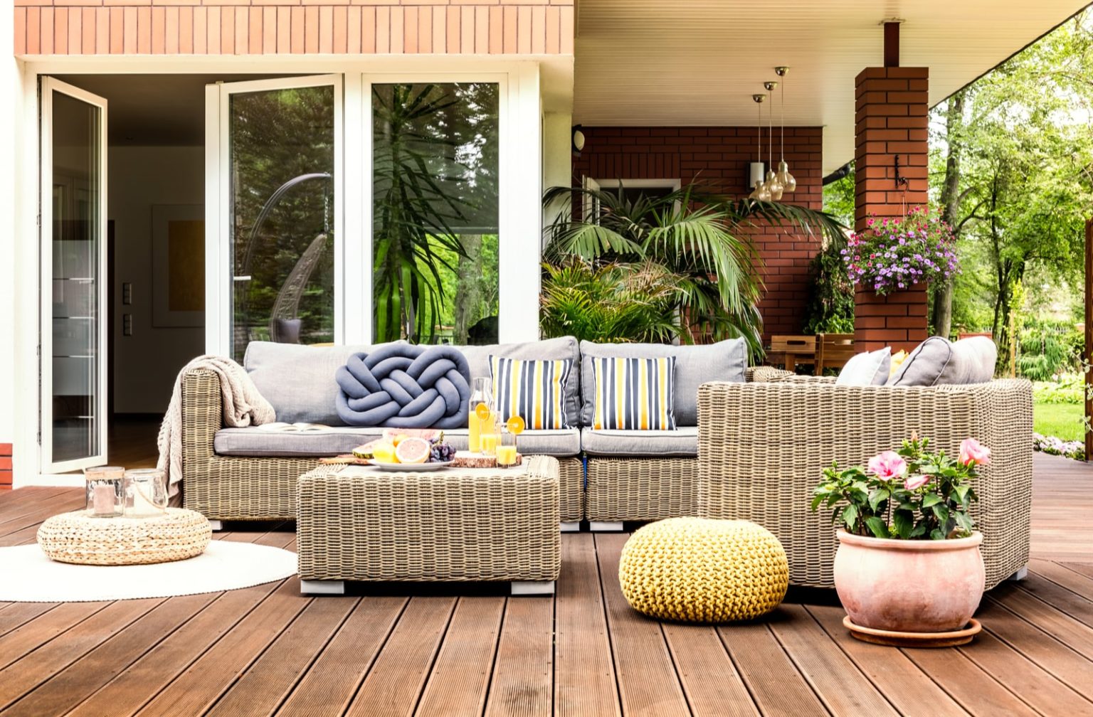 Wicker outdoor furniture surrounded by plants