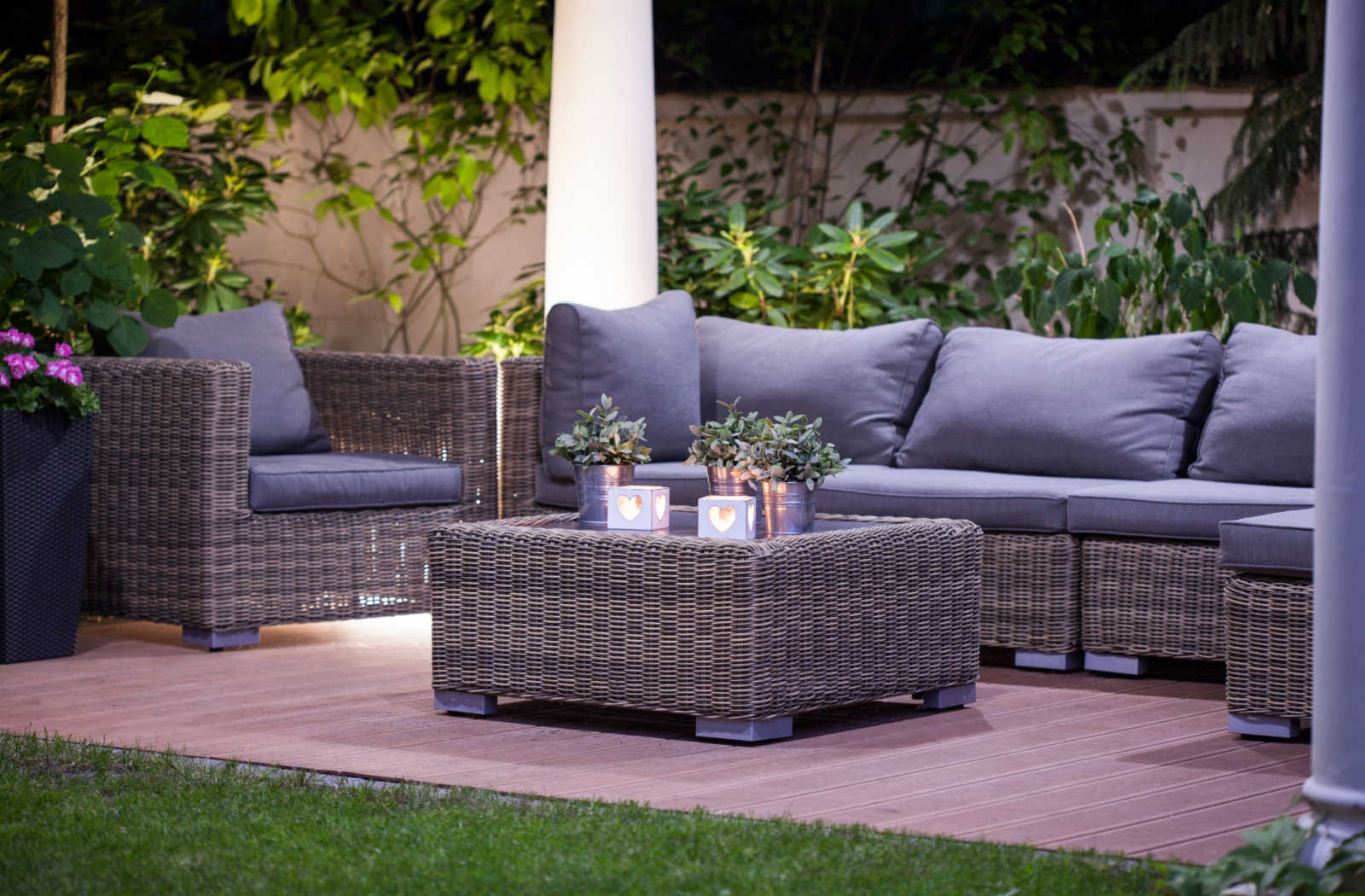 Resin wicker outdoor furniture, including a couch, chair, and coffee table
